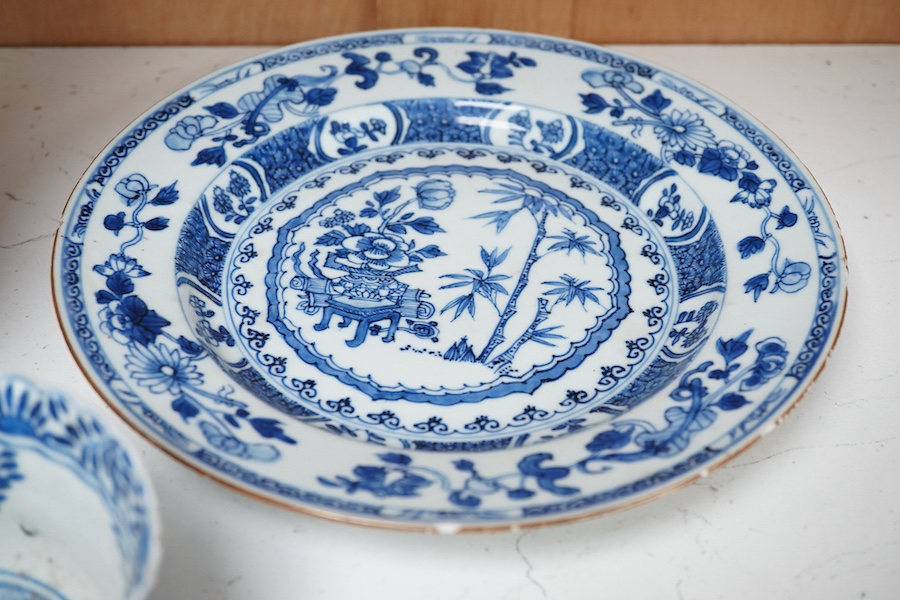 An early 20th century Chinese blue and white sleeve vase, 18th century plate and bowl, tallest 24.5cm